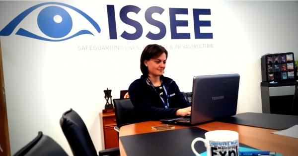 An member of ISSEE office staff working on a laptop